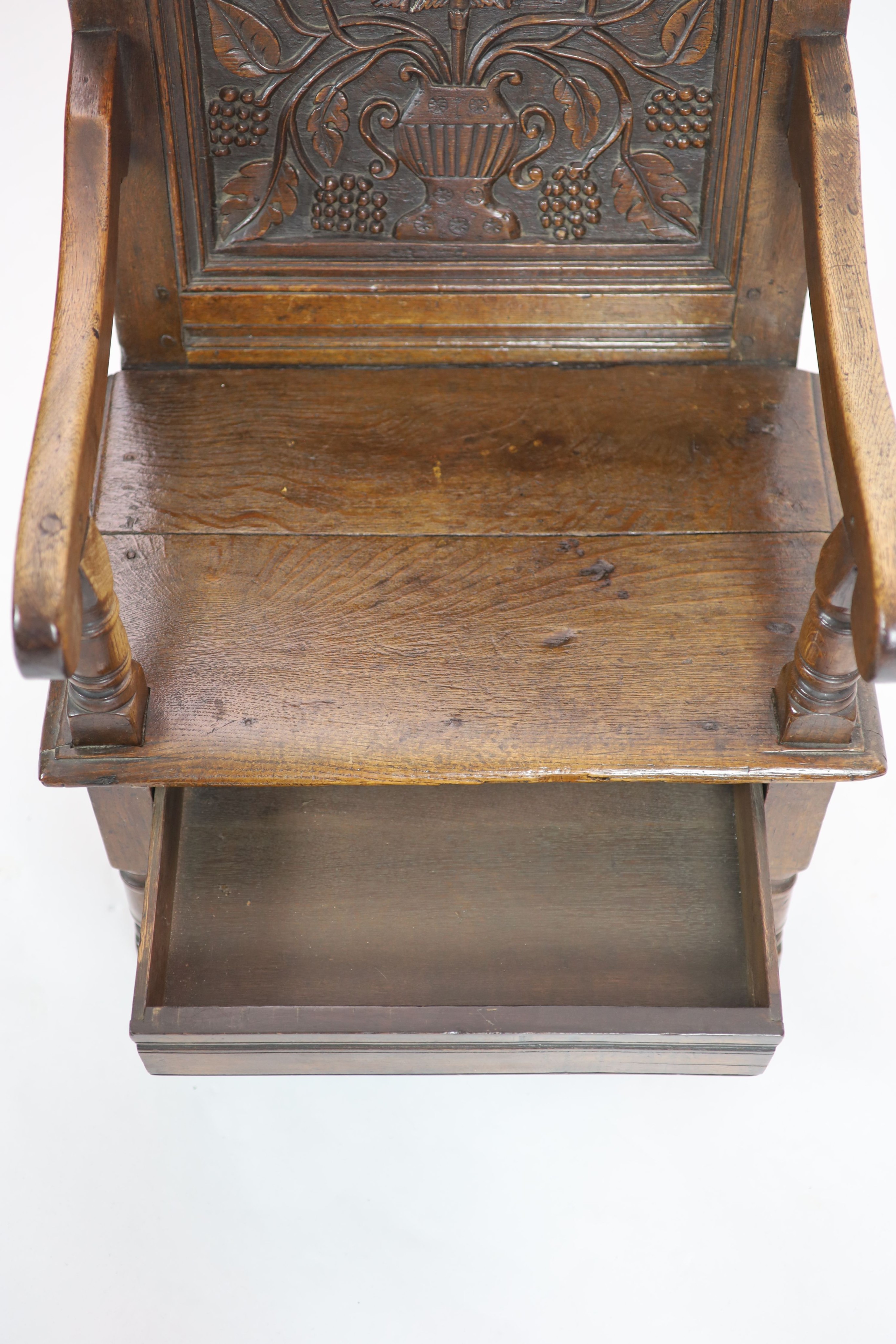 A South Lancashire/North Cheshire Charles II carved and panelled oak open armchair H 93cm. W 60cm. D 53cm.